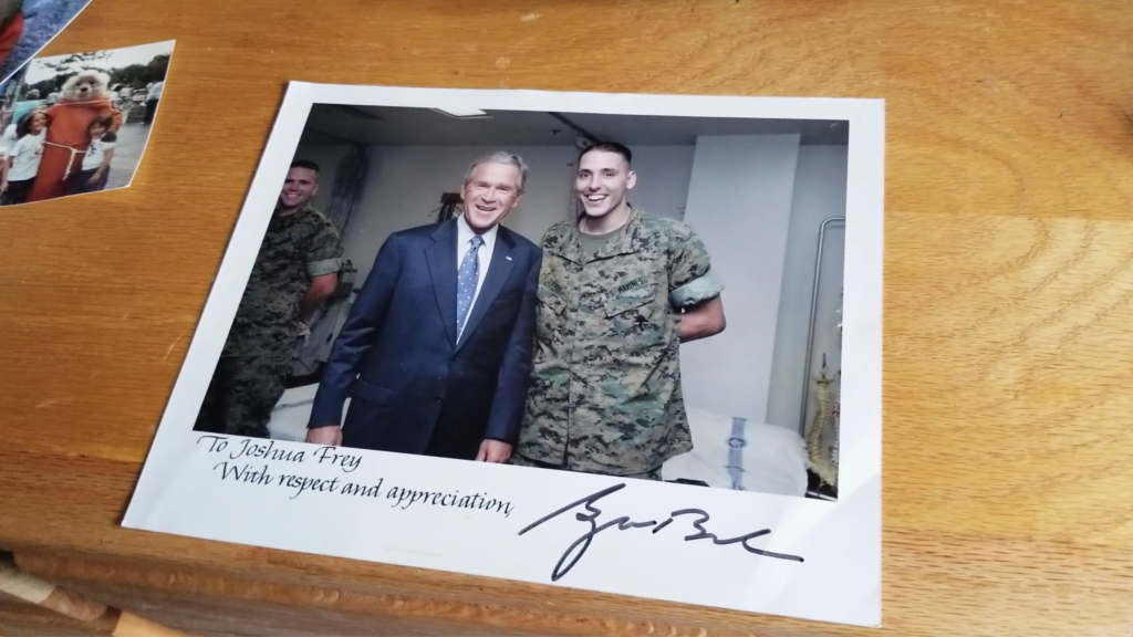Joshua James Frey pictured with former President George W. Bush. Frey served in Iraq and was awarded two Purple Hearts before coming back home. Afterwards, he fell into depression and anxiety until he quit his medications and took marijuana. (Photo credit: Steve Ellmore)