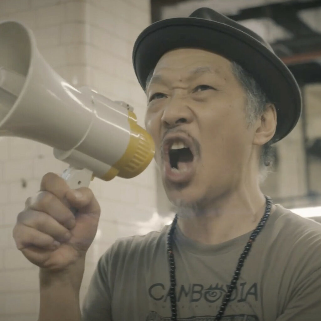 Perry Yung uses a megaphone